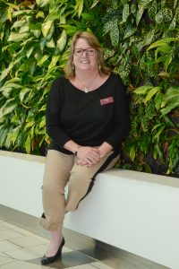 Peggy Howard, General Manager of GTC in front of the Living Wall. Photo by Ray Hudson