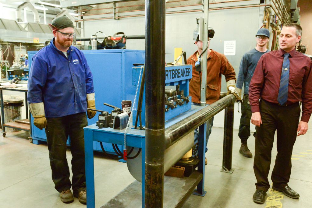 Dean Brian Haugen explains a weld failure pressure test to Surrey Board of Trade visitors to the welding lab. Photo by Ray Hudson