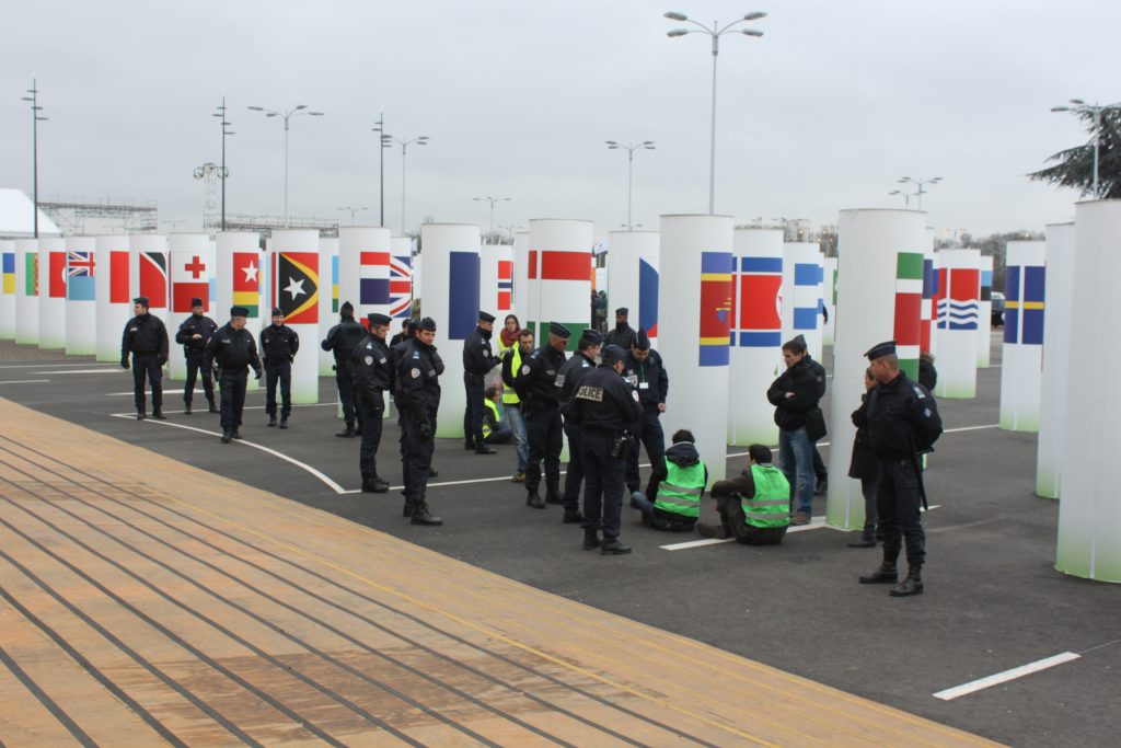 Just to handle a couple of protesters at CoP21 gate, more than a dozen policeman turn up. (Photo: IANS)