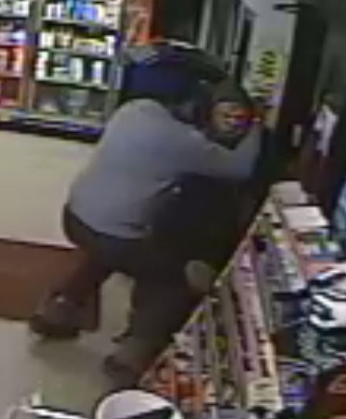 Amrik Singh is seen grappling with a masked gunman Tuesday (Dec. 15, 2015) at his petrol station in Staatsburg, about 160 km from New York City, in a still from a surveillance video. Singh threw a slipper at the gunman trying to rob the store and charged at him. The gunman fled after firing a shot that missed Singh. (Credit: Courtesy of New York State Police)
