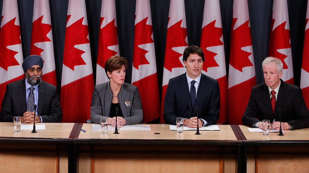 The Prime Minister, Justin Trudeau, along with the Minister of Foreign Affairs, the Honourable Stéphane Dion (right), the Minister of National Defence, the Honourable Harjit S. Sajjan (furthest left), and the Minister of International Development and La Francophonie, the Honourable Marie-Claude Bibeau (left), make an important announcement in Ottawa. Photo: PMO