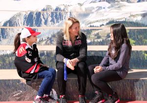 Gabriella Lee, 8 years old, and Hayley Lee, 12 years old, of the Surrey Falcons sit and talk hockey and their ideas for WickFest Surrey with Hayley Wickenheiser on the steps of Surrey City Hall.