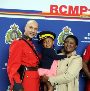 New Canadians pose with members of the Royal Canadian Mounted Police.